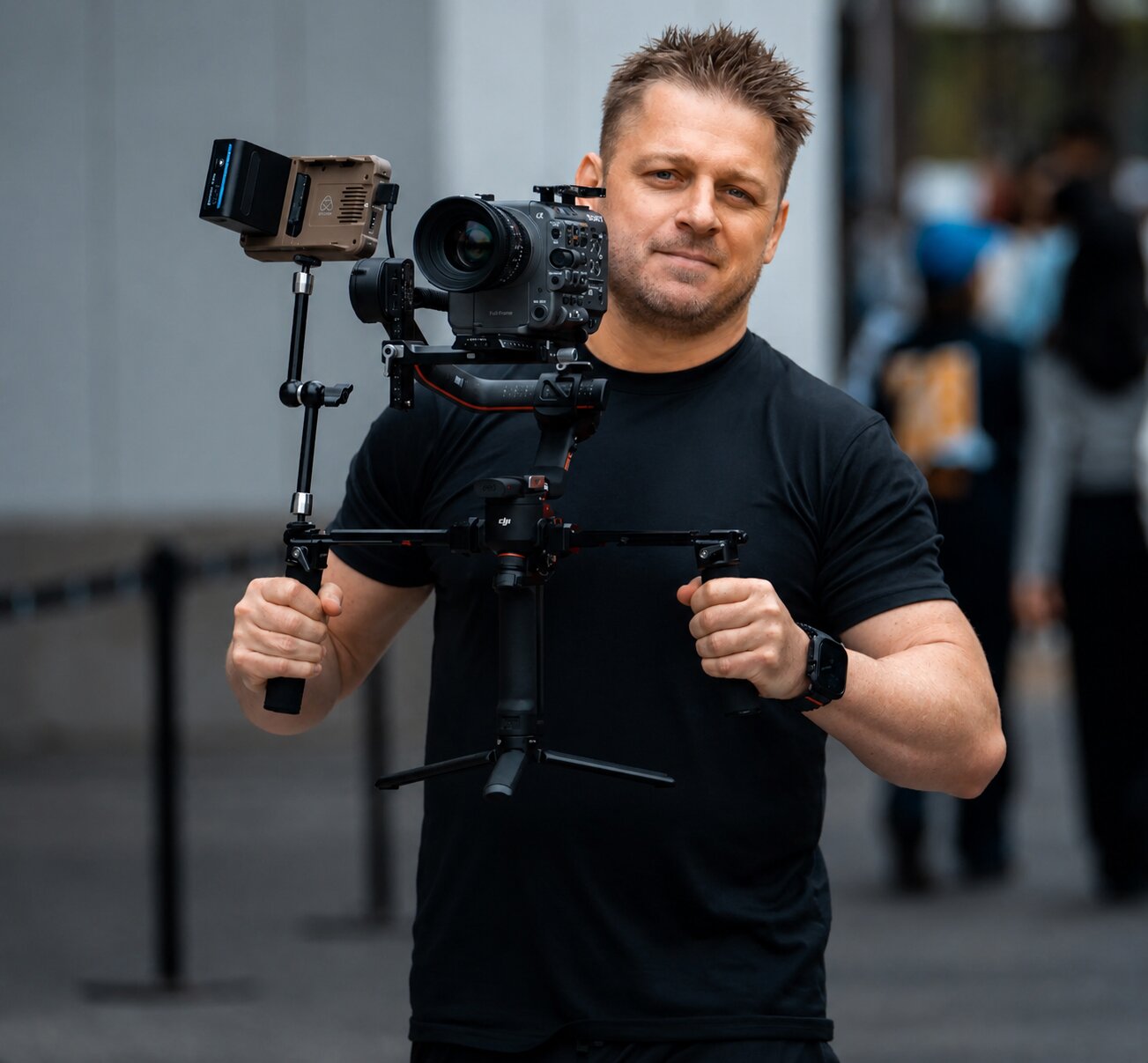 Rionne McAvoy holding a cinema camera rig on location