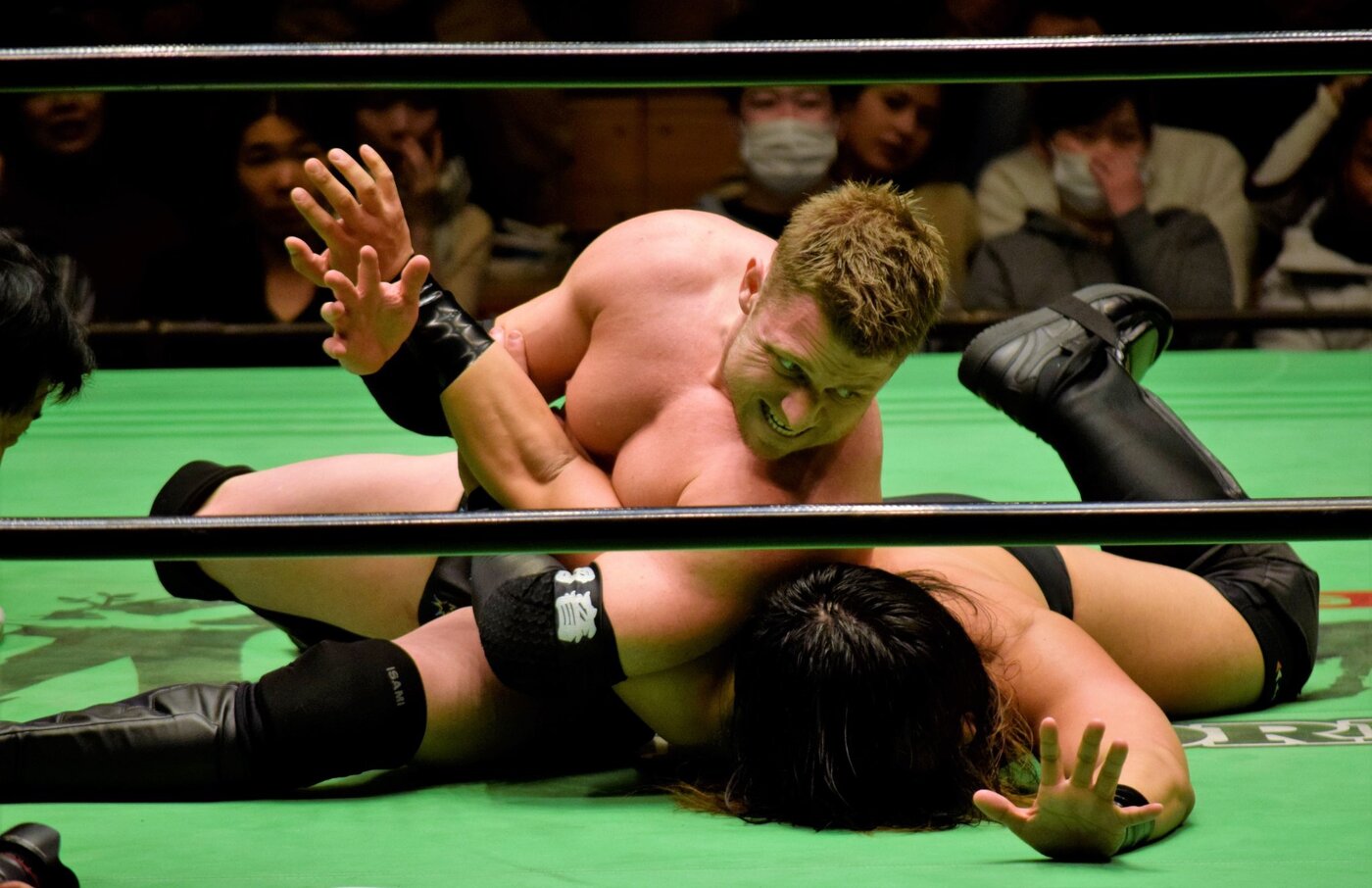 Rionne Fujiwara applying a submission hold in the ring